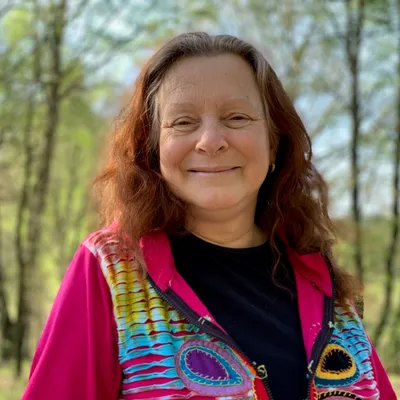 Woman smiling outdoors in a forest