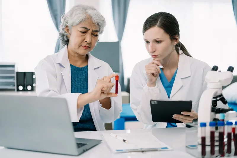 A scientist using a pipette with a test tube in a biotechnology laboratory