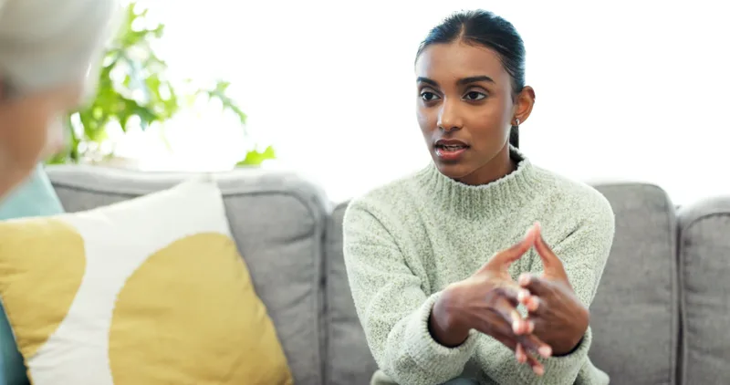 A woman in conversation with a therapist during a mental health consultation