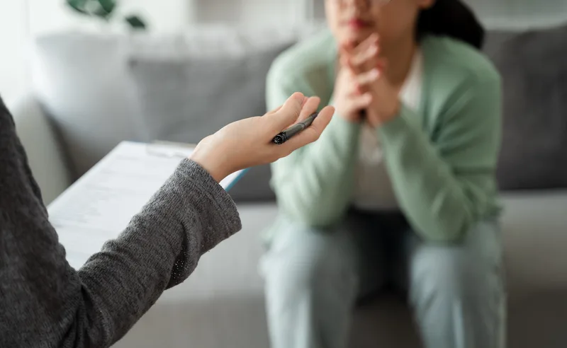 A psychologist listening to a patient describing depression and anxiety